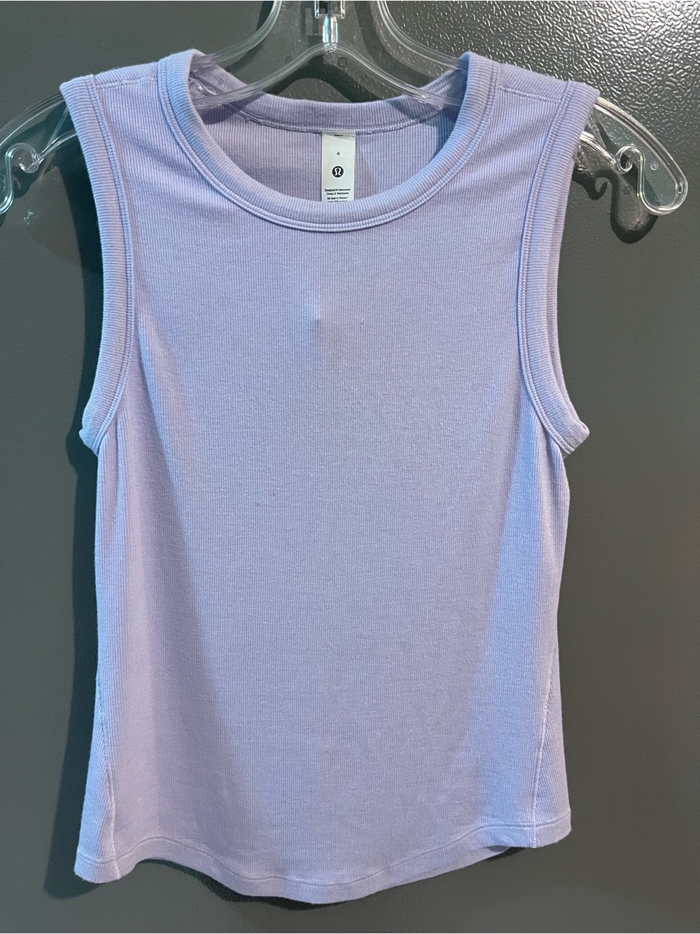 Lululemon tank top has small tear can barely see stains can be washed off